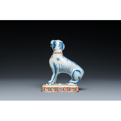 1322 - A polychrome Dutch Delft dog seated on a plinth, 18th C.H.: 12 cm
 
 Provenance:- A private collecti... 