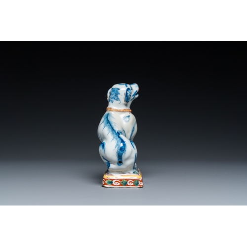 1322 - A polychrome Dutch Delft dog seated on a plinth, 18th C.H.: 12 cm
 
 Provenance:- A private collecti... 