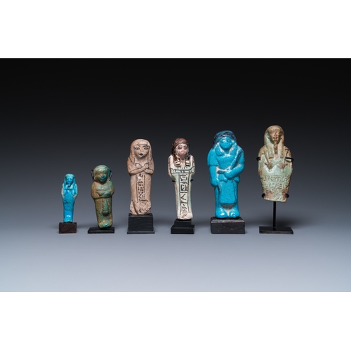 1401 - Six Egyptian green- and turquoise-glazed frit ushabtis, Late PeriodH.: 17 cm (the tallest incl. stan... 