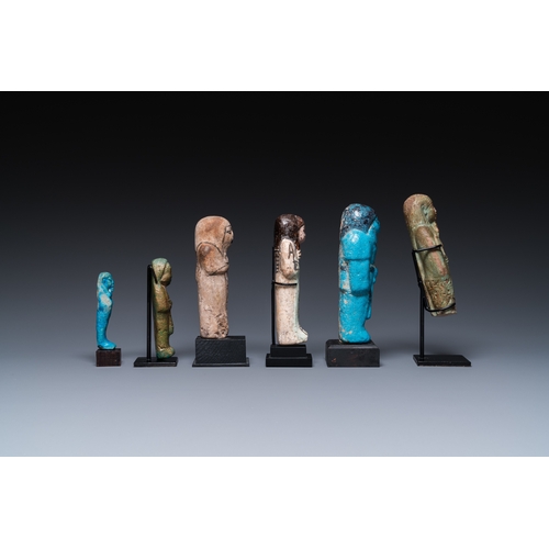 1401 - Six Egyptian green- and turquoise-glazed frit ushabtis, Late PeriodH.: 17 cm (the tallest incl. stan... 