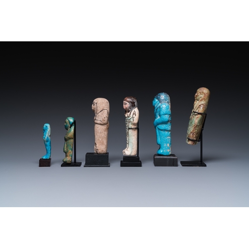 1401 - Six Egyptian green- and turquoise-glazed frit ushabtis, Late PeriodH.: 17 cm (the tallest incl. stan... 