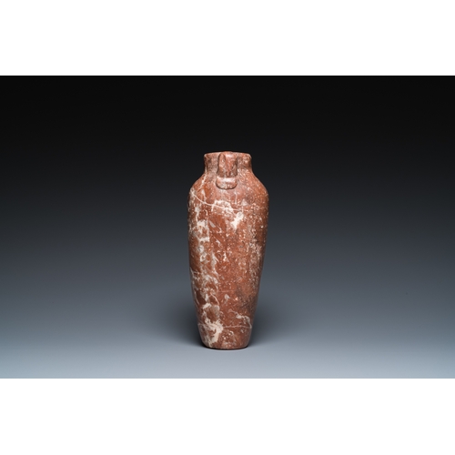 1406 - An Egyptian red Breccia jar, Predynastic period, 3500-2900 b.C.H.: 28,5 cm (the vase)
 
 Provenance:... 