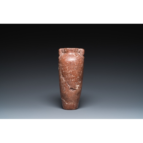 1406 - An Egyptian red Breccia jar, Predynastic period, 3500-2900 b.C.H.: 28,5 cm (the vase)
 
 Provenance:... 