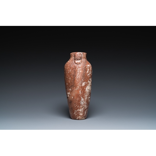 1406 - An Egyptian red Breccia jar, Predynastic period, 3500-2900 b.C.H.: 28,5 cm (the vase)
 
 Provenance:... 