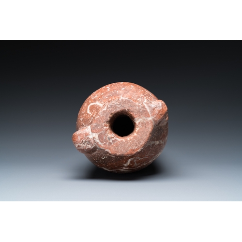 1406 - An Egyptian red Breccia jar, Predynastic period, 3500-2900 b.C.H.: 28,5 cm (the vase)
 
 Provenance:... 