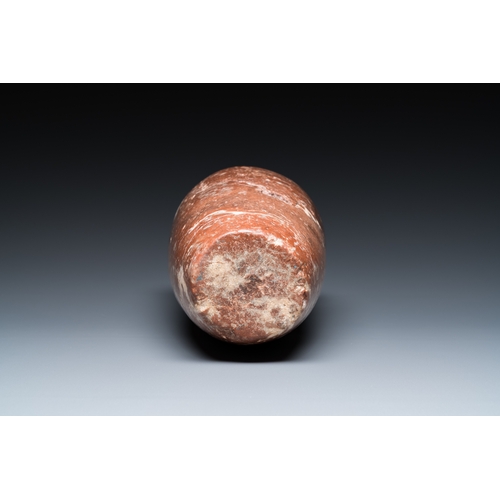 1406 - An Egyptian red Breccia jar, Predynastic period, 3500-2900 b.C.H.: 28,5 cm (the vase)
 
 Provenance:... 