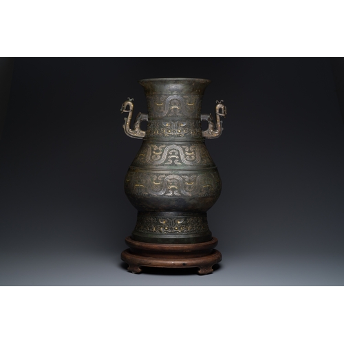 254 - An imposing Chinese archaistic gold-and-silver-inlaid bronze 'hu' vase on wooden stand inscribed Tao... 