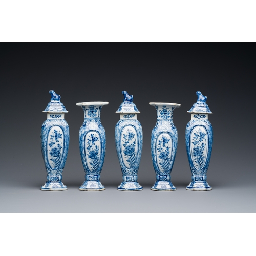 349 - A small blue and white Dutch Delft garniture of five vases, 18th C.Description:H.: 18 cm (tallest va... 