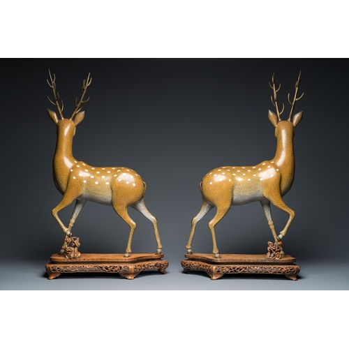 45 - A very fine and large pair of Chinese cloisonne models of deer on reticulated wooden stands, 19th C.... 