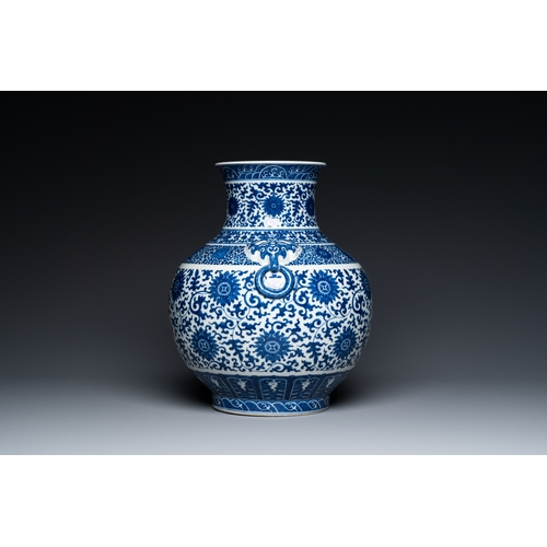 53 - A Chinese blue and white 'hu' vase with lotus scrolls, Qianlong mark, 19th C.Description:H.: 33,5 cm... 