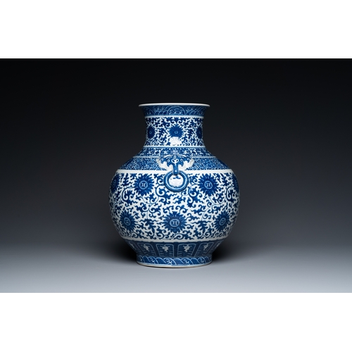 53 - A Chinese blue and white 'hu' vase with lotus scrolls, Qianlong mark, 19th C.Description:H.: 33,5 cm... 