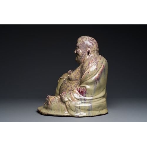 65 - A massive Chinese flambe-glazed Shiwan pottery figure of Buddha, 18/19th C.Description:H.: 47,5 cm (... 