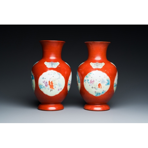 77 - A pair of Chinese coral-ground famille rose vases with medallions showing playing boys, 18/19th C.De... 