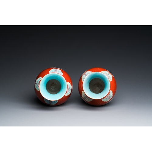 77 - A pair of Chinese coral-ground famille rose vases with medallions showing playing boys, 18/19th C.De... 