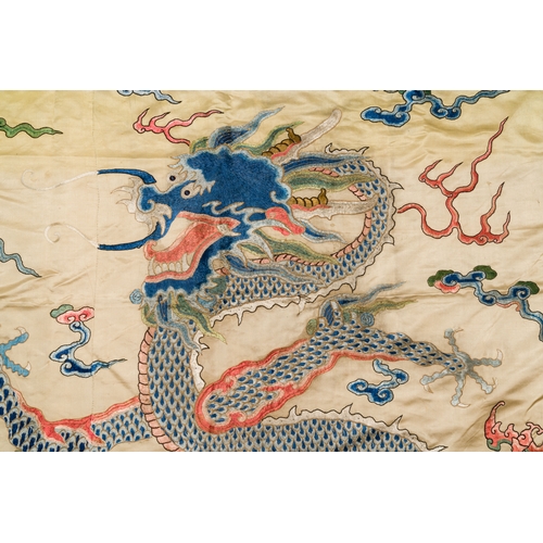 105 - A large Chinese yellow-ground silk embroidery decorated with three five-clawed dragons, 19th C.Descr... 