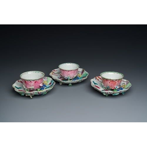 226 - Three Chinese relief-decorated famille rose 'lotus' cups and saucers with a scholar and his servant,... 