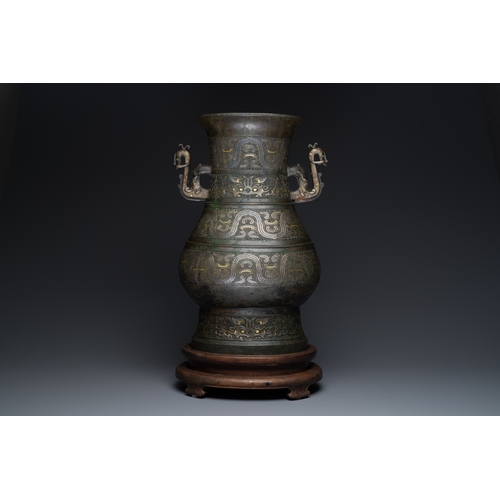 254 - An imposing Chinese archaistic gold-and-silver-inlaid bronze 'hu' vase on wooden stand inscribed Tao... 