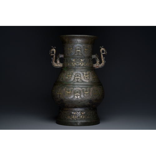 254 - An imposing Chinese archaistic gold-and-silver-inlaid bronze 'hu' vase on wooden stand inscribed Tao... 