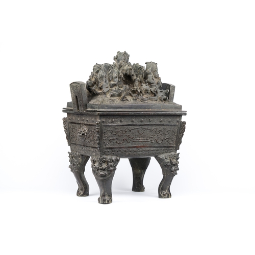 257 - A large Chinese bronze censer and cover with a dragon in a rocky landscape with various animals, Yua... 