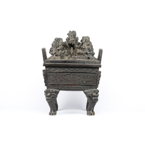 257 - A large Chinese bronze censer and cover with a dragon in a rocky landscape with various animals, Yua... 