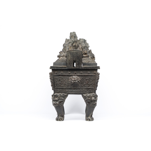 257 - A large Chinese bronze censer and cover with a dragon in a rocky landscape with various animals, Yua... 