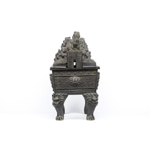 257 - A large Chinese bronze censer and cover with a dragon in a rocky landscape with various animals, Yua... 