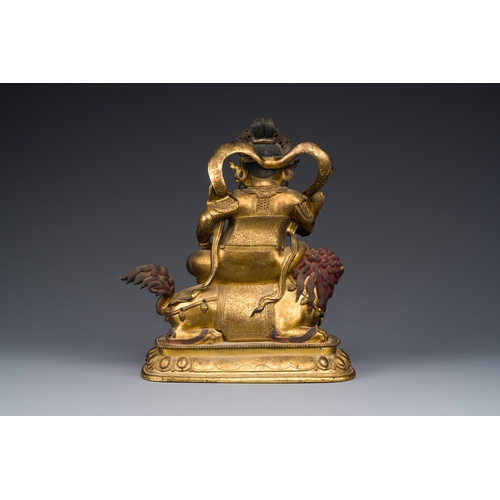 261 - A Sino-Tibetan gilt bronze sculpture of Vaishravana on a Buddhist lion, probably 17th C.Description:... 