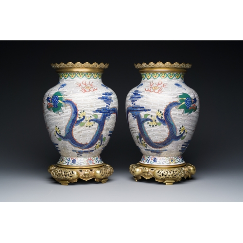 115 - A pair of Chinese white-ground cloisonne 'dragon' vases with gilt bronze mounts, 19th C.Description:... 