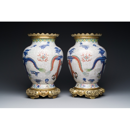 115 - A pair of Chinese white-ground cloisonne 'dragon' vases with gilt bronze mounts, 19th C.Description:... 