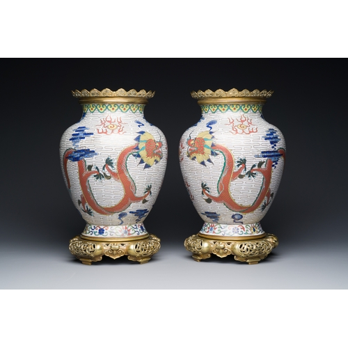 115 - A pair of Chinese white-ground cloisonne 'dragon' vases with gilt bronze mounts, 19th C.Description:... 