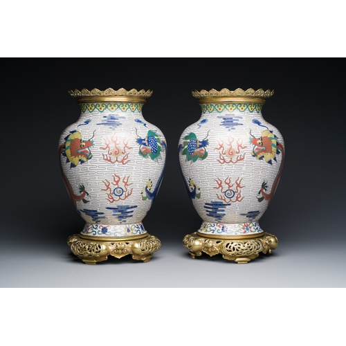 115 - A pair of Chinese white-ground cloisonne 'dragon' vases with gilt bronze mounts, 19th C.Description:... 