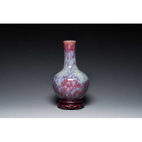 119 - A Chinese flambe-glazed bottle vase, 19th C.Description:H.: 39 cm (the vase)H.: 42 cm (incl. the sta... 