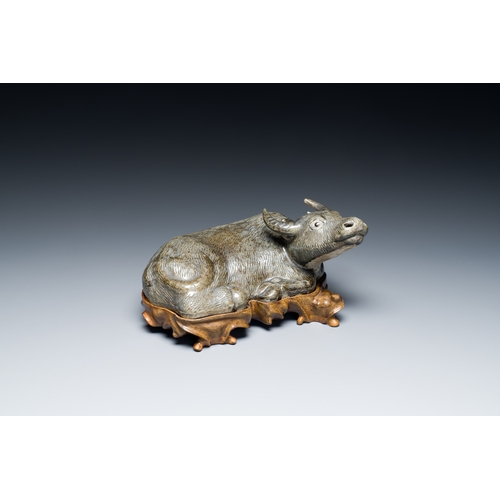 154 - A Chinese monochrome brown-grey-glazed sculpture of a reclining water buffalo on wooden stand, 19th ... 