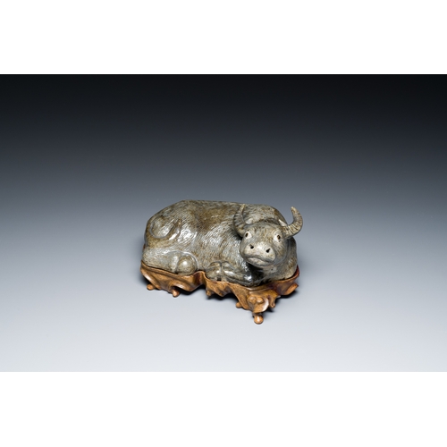 154 - A Chinese monochrome brown-grey-glazed sculpture of a reclining water buffalo on wooden stand, 19th ... 