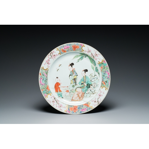 229 - A Chinese famille rose dish with two ladies and a boy in a garden, YongzhengDescription:Dia.: 38 cm ... 