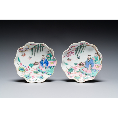 255 - A pair of Chinese relief-decorated famille rose 'lotus' cups and saucers with a scholar and his serv... 