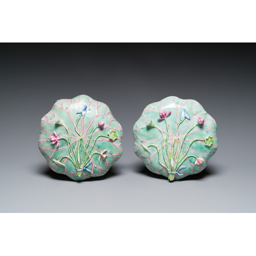 255 - A pair of Chinese relief-decorated famille rose 'lotus' cups and saucers with a scholar and his serv... 