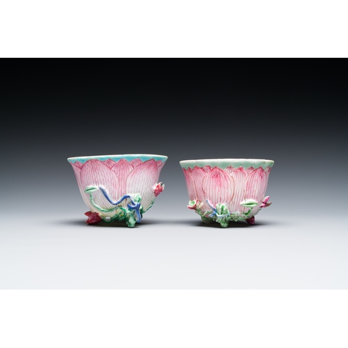 255 - A pair of Chinese relief-decorated famille rose 'lotus' cups and saucers with a scholar and his serv... 