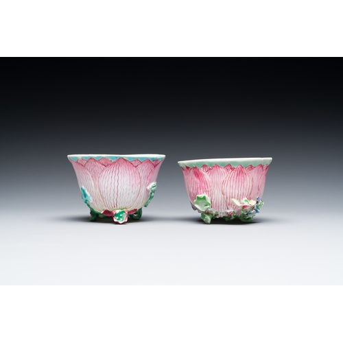 255 - A pair of Chinese relief-decorated famille rose 'lotus' cups and saucers with a scholar and his serv... 