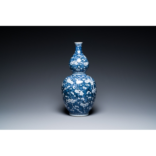 311 - A Chinese blue and white double gourd 'prunus on cracked ice' vase, 18th C.Description:H.: 49 cmCond... 