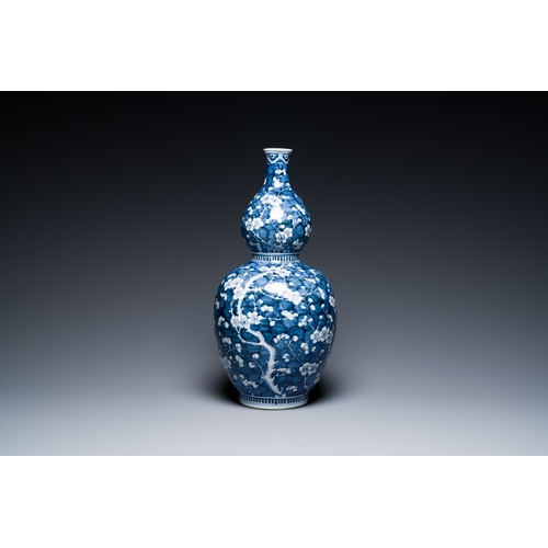 311 - A Chinese blue and white double gourd 'prunus on cracked ice' vase, 18th C.Description:H.: 49 cmCond... 