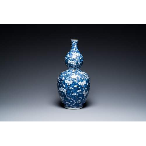 311 - A Chinese blue and white double gourd 'prunus on cracked ice' vase, 18th C.Description:H.: 49 cmCond... 