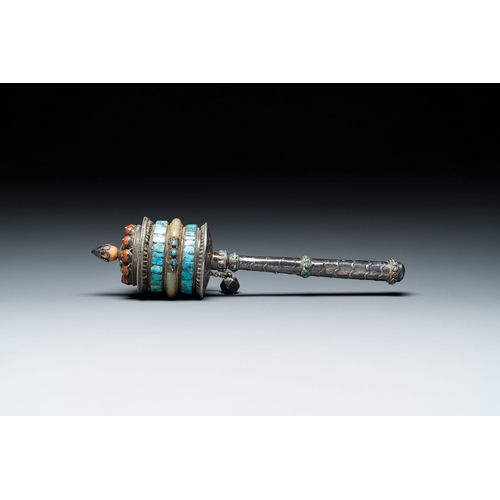 401 - A Tibetan silver prayer wheel with turquoise and coral inlay, 19th C.Description:L.: 25 cmCondition ... 