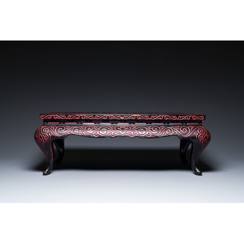 422 - A Chinese rectangular carved red and black lacquer table, 'kang', Xuande mark, 20th C.Description:Di... 