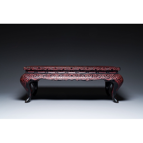 422 - A Chinese rectangular carved red and black lacquer table, 'kang', Xuande mark, 20th C.Description:Di... 