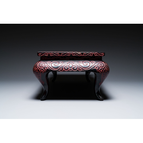 422 - A Chinese rectangular carved red and black lacquer table, 'kang', Xuande mark, 20th C.Description:Di... 