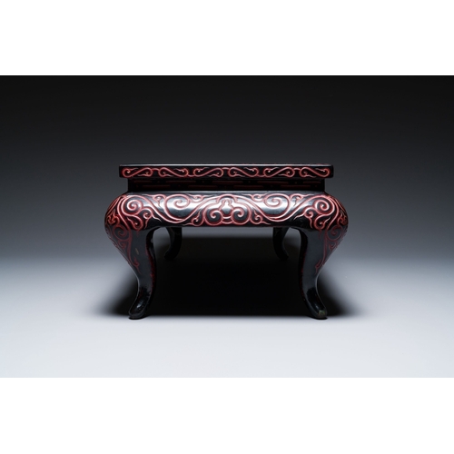 422 - A Chinese rectangular carved red and black lacquer table, 'kang', Xuande mark, 20th C.Description:Di... 