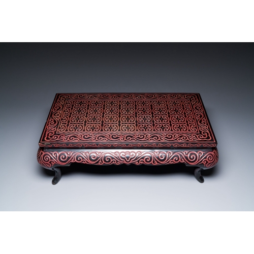 422 - A Chinese rectangular carved red and black lacquer table, 'kang', Xuande mark, 20th C.Description:Di... 