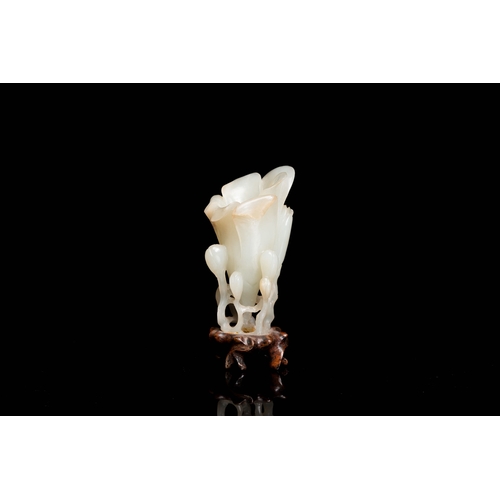 485 - A Chinese white jade 'magnolia' carving, QingDescription:H.: 8 cm (incl. glued stand) Provenance:- T... 