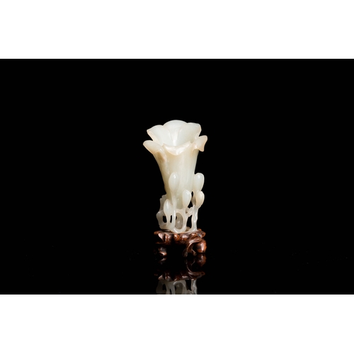 485 - A Chinese white jade 'magnolia' carving, QingDescription:H.: 8 cm (incl. glued stand) Provenance:- T... 